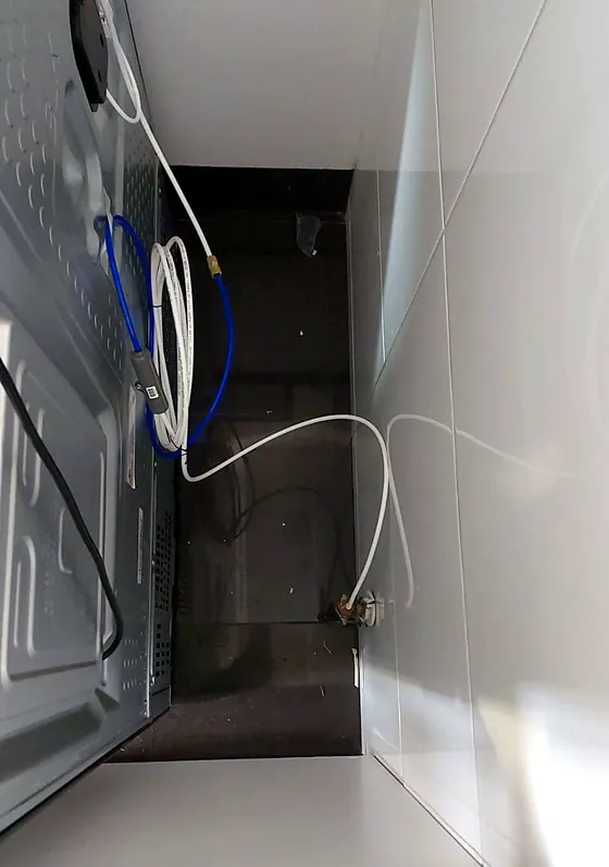 Conexión a la toma de agua, con la manguera ordenada detrás del equipo